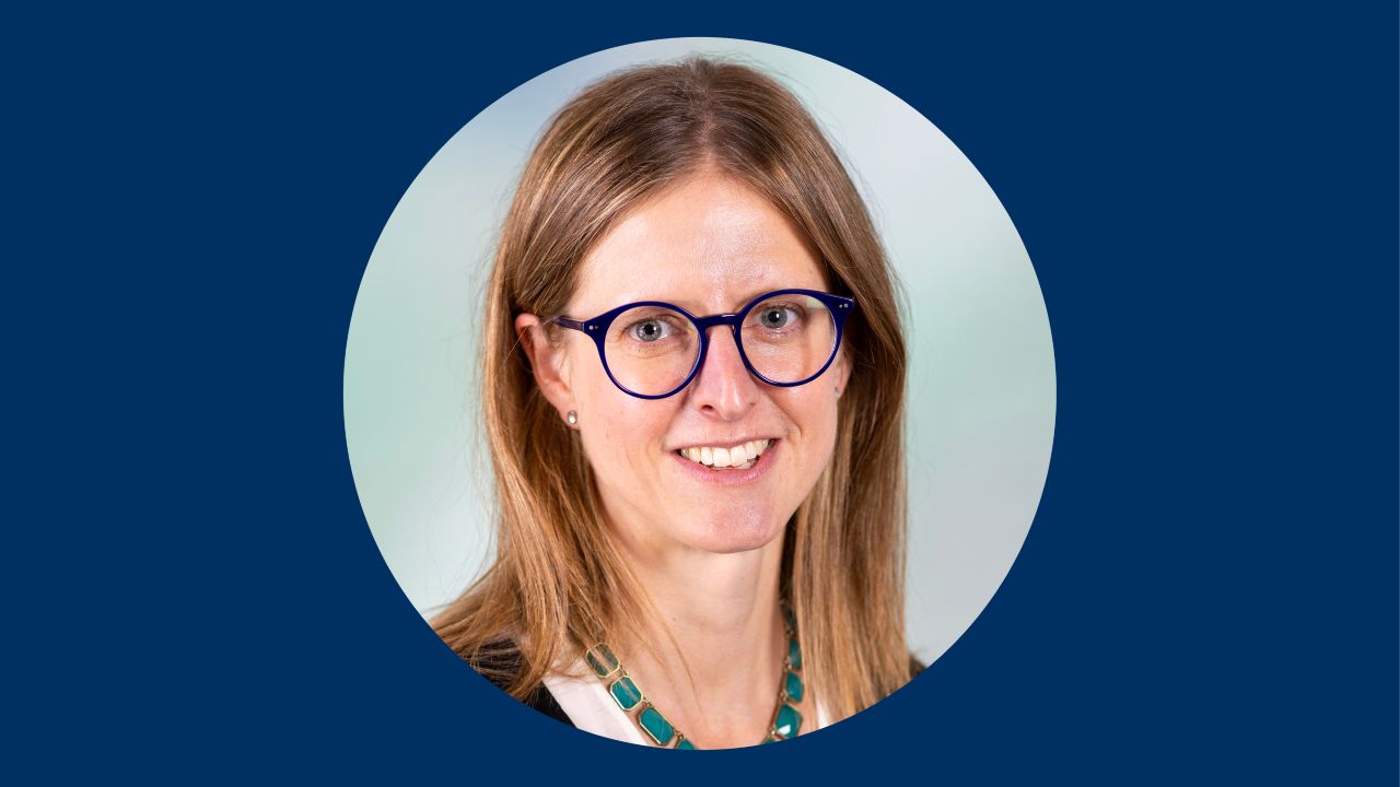 A headshot of Sarah Taylor, MD, on a dark blue background