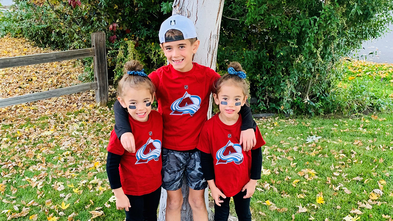 Zoey and Kenna pose with their older brother in matching Avalanche t-shirts