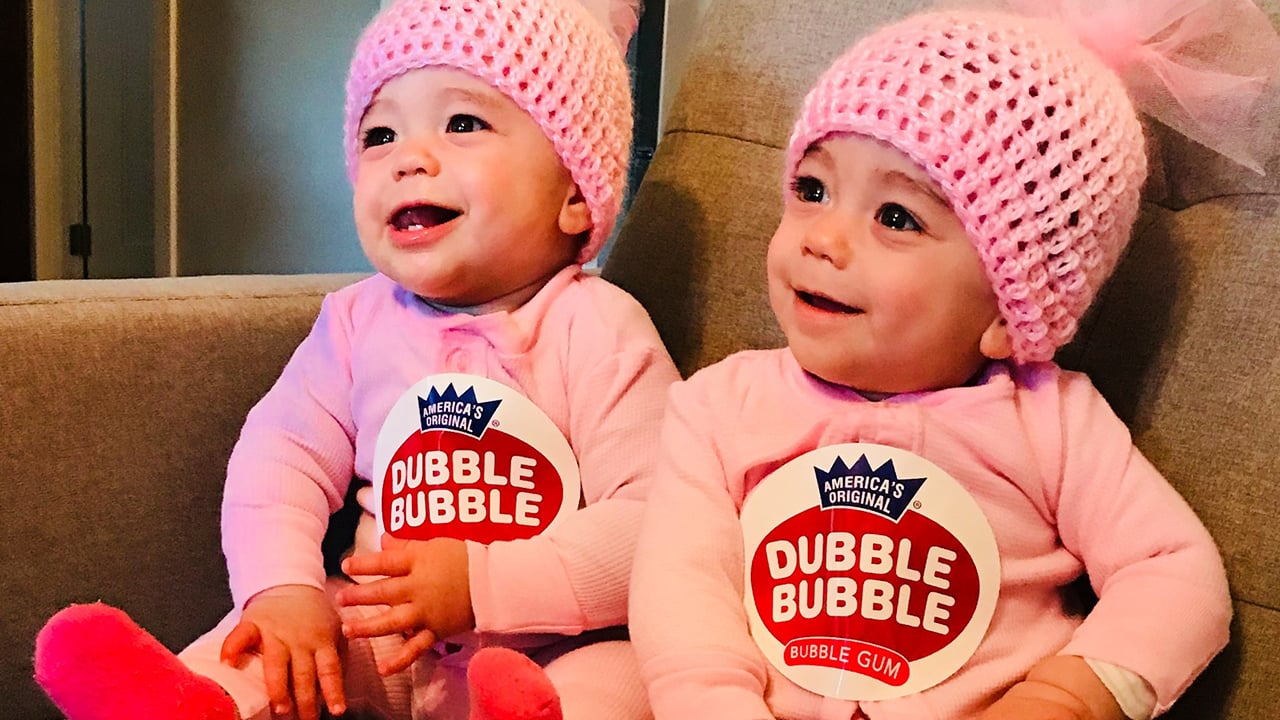 Zoey and Kenna as babies dressed in matching pink Dubble Bubble costumes