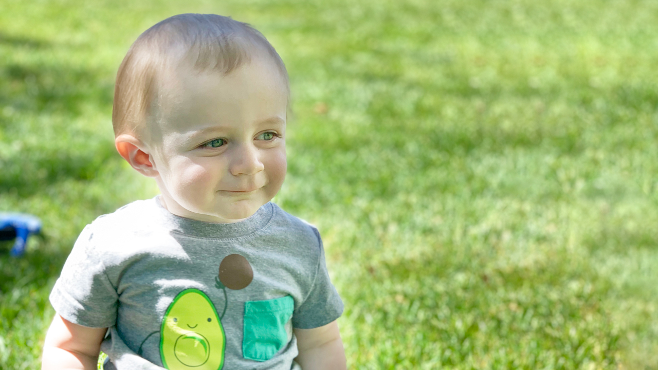 Eli sitting on the grass