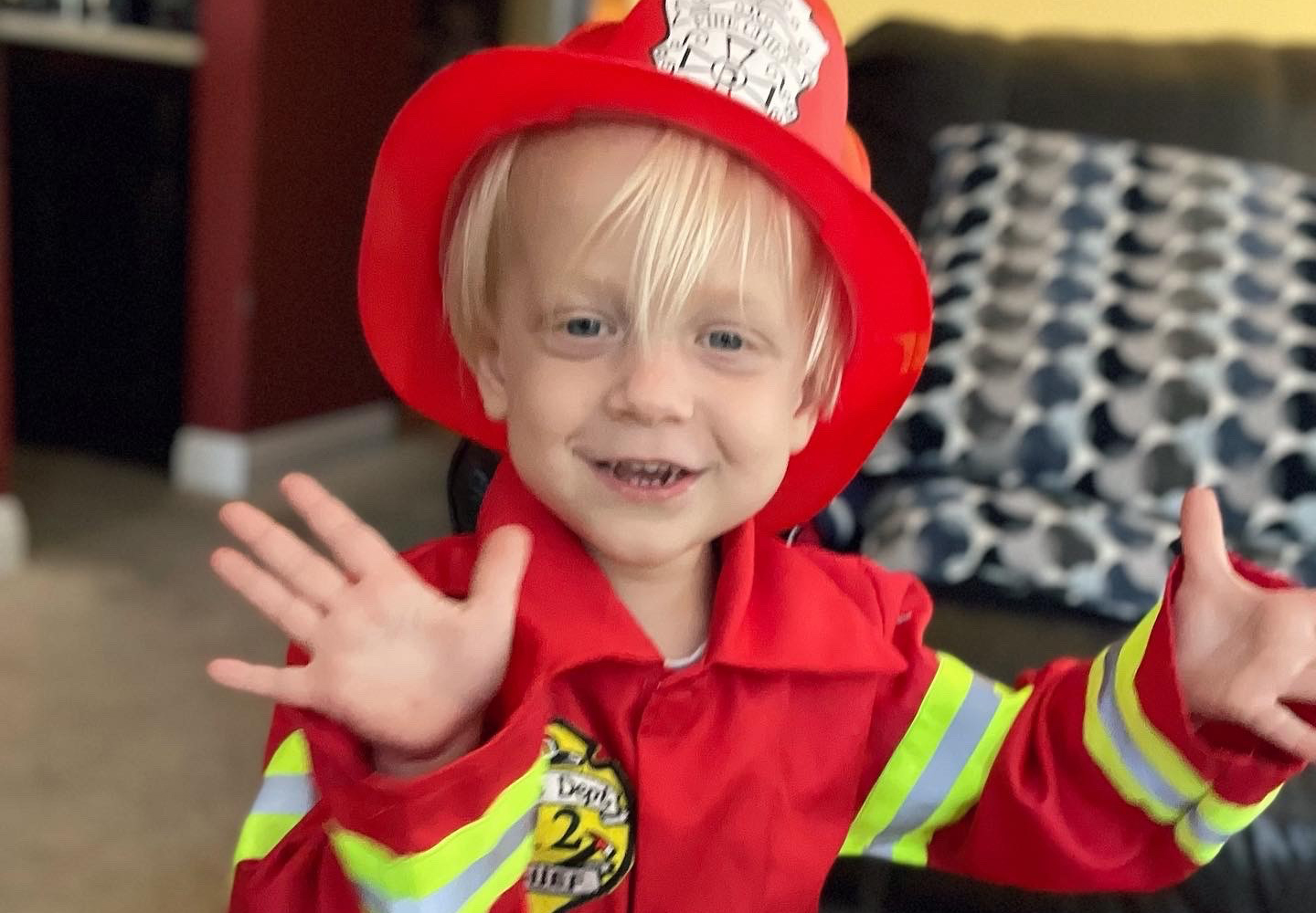 Everett dressed up in a fireman's uniform.