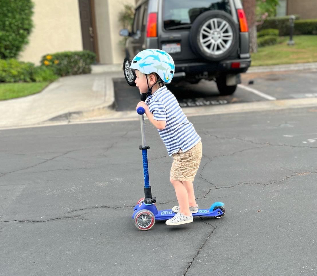 Everett riding around on a scooter.