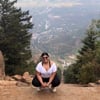 Mona posing at the top of a mountain path she climbed after bariatric surgery