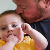 Dad Kelly kisses his son on the head. His son is being treated for HLHS at Children's Hospital Colorado.