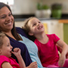 Nicole, treated for TTTS at Children's Colorado, sits with her school-age twin girls.