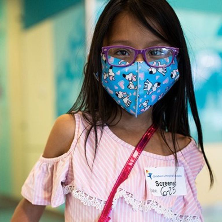 Girl wearing a mask.