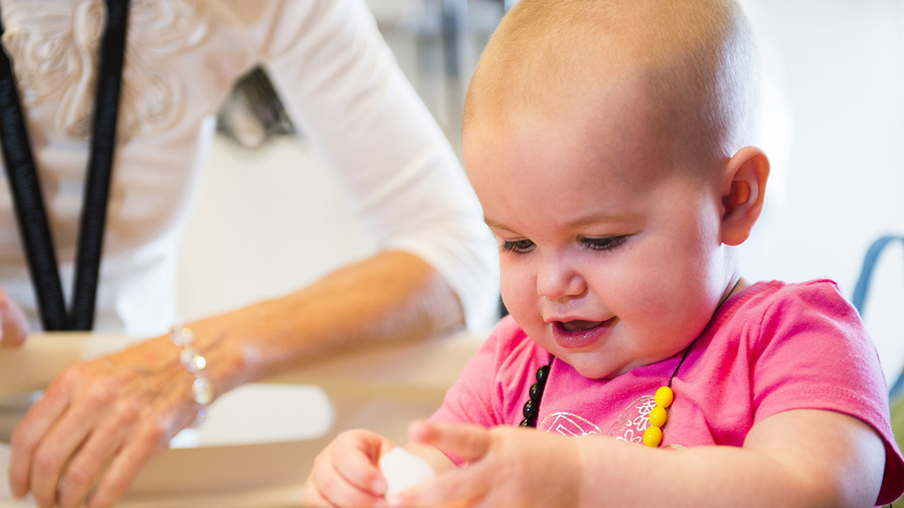 A young girl playing with a toy