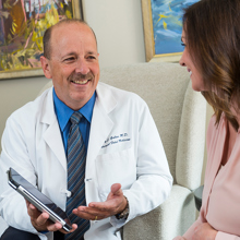 Dr. Galan talks with a woman in the maternal fetal program.