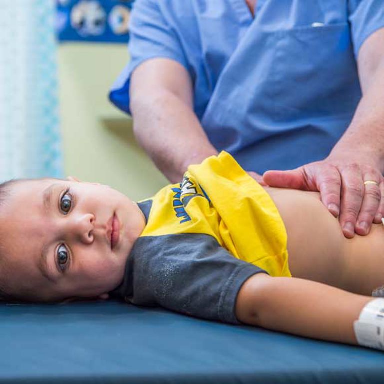 A provider checks a child's stomach