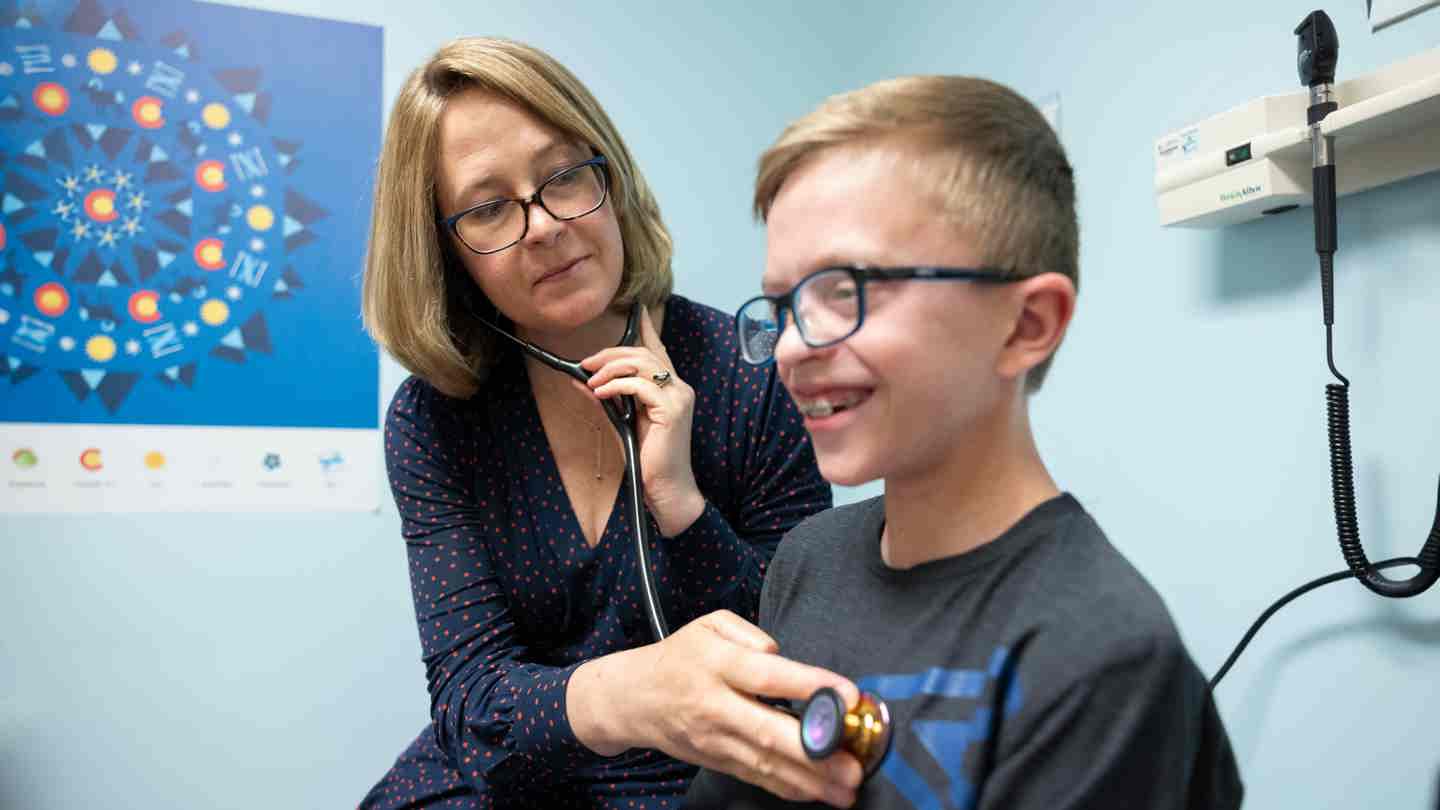 Dr. Kathryn Chatfield, a cardiac geneticist at Children’s Hospital Colorado, examines a pediatric heart patient.