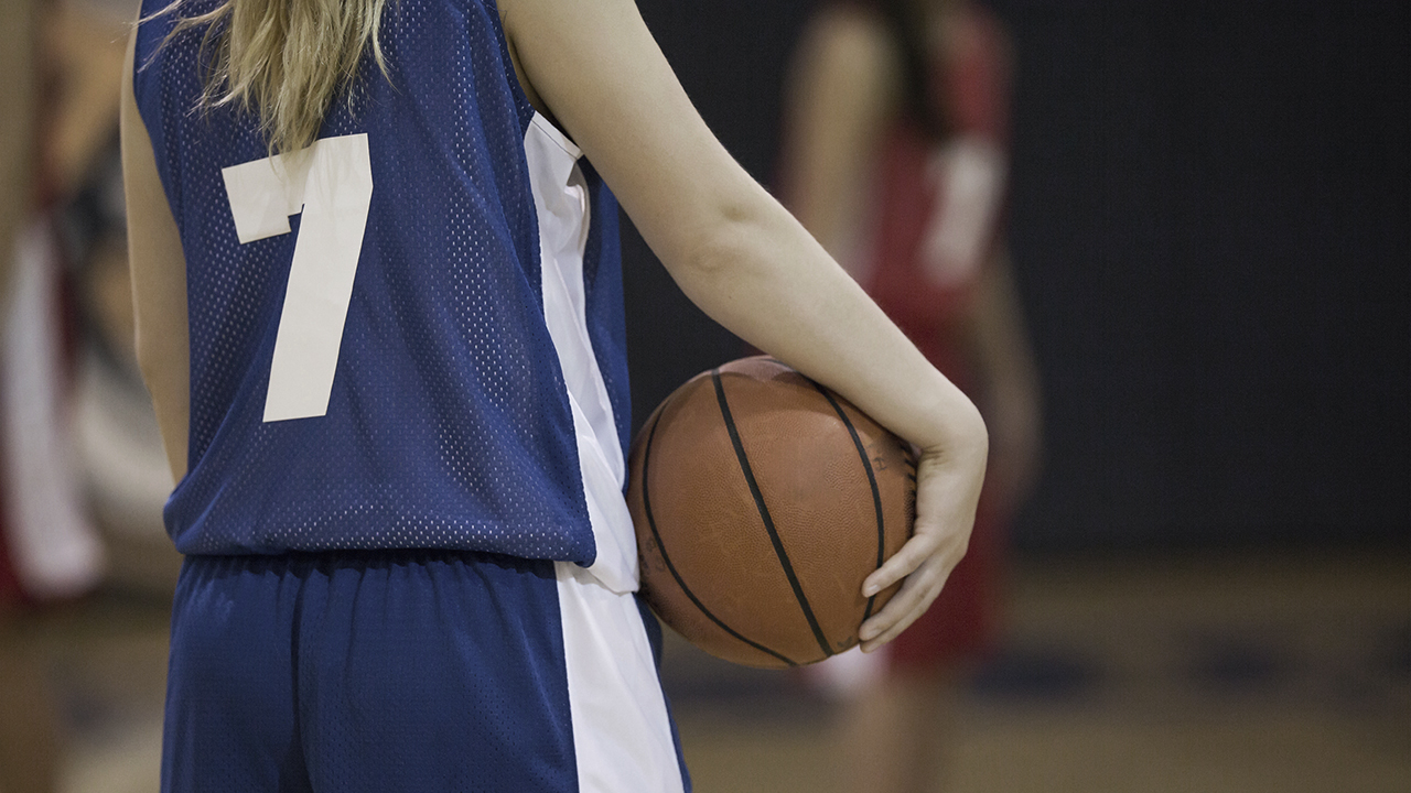 A girl holding a basketball