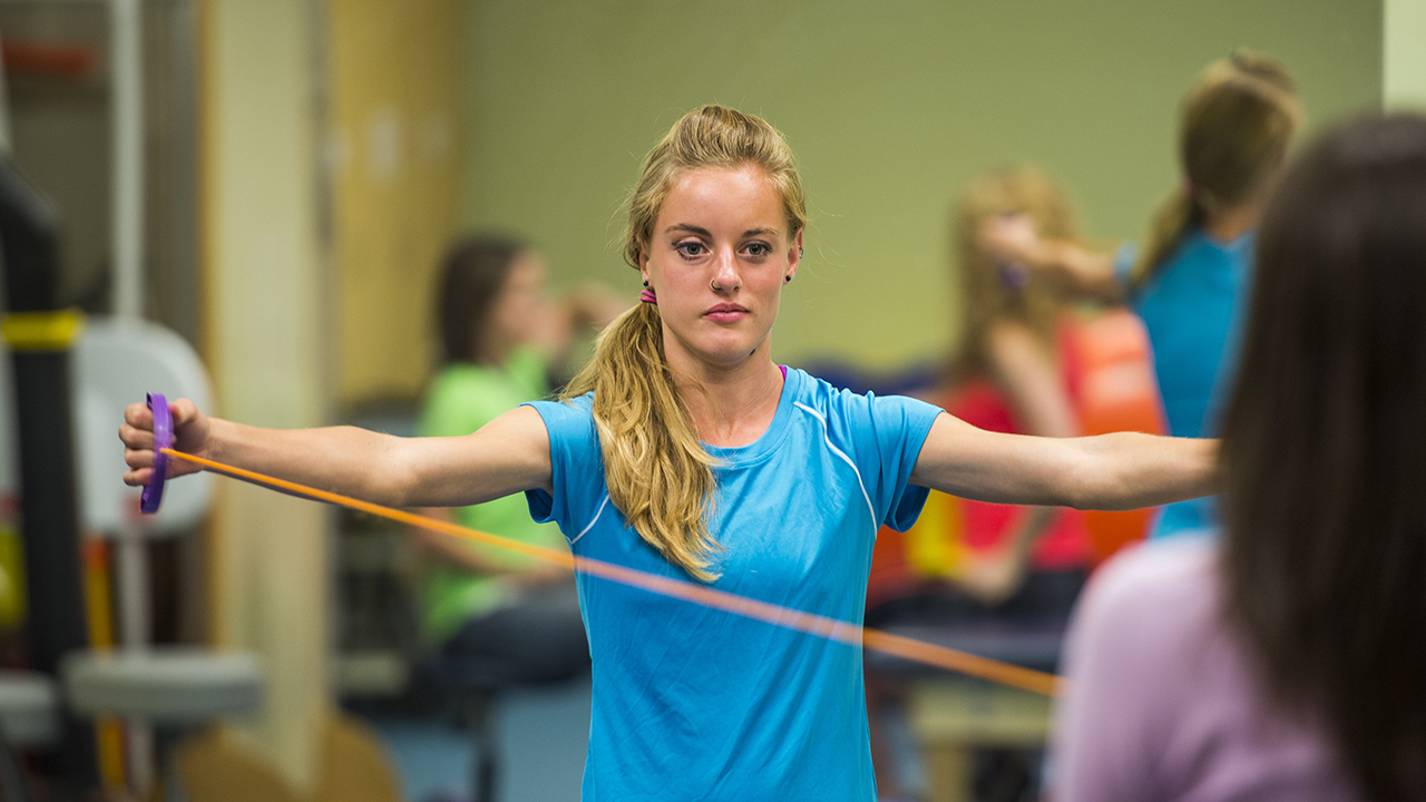 A teenager does physical therapy exercises