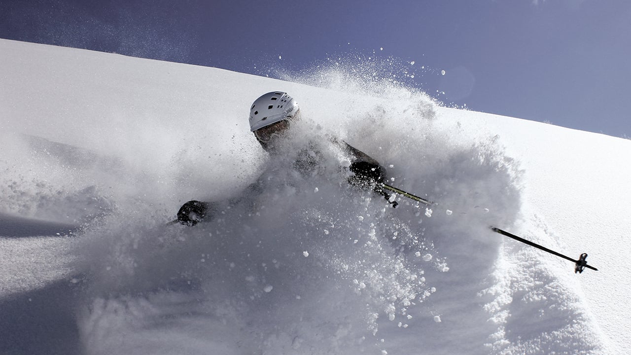 A skier going down a mountain