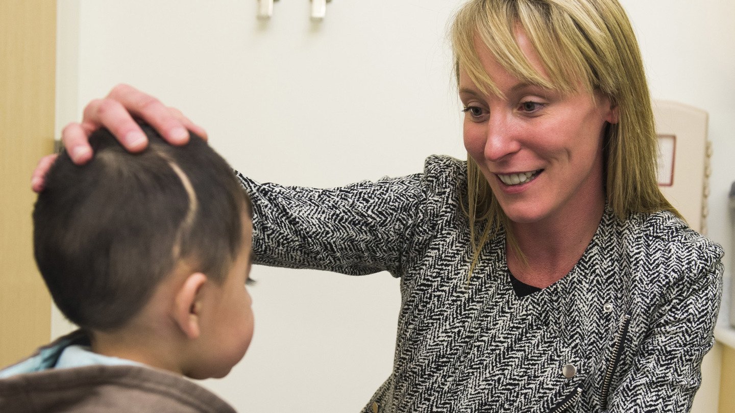 Dr. Brooke French examines a young boy at Children's Hospital Colorado's Craniofacial Program