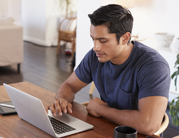 Man on computer researching prices