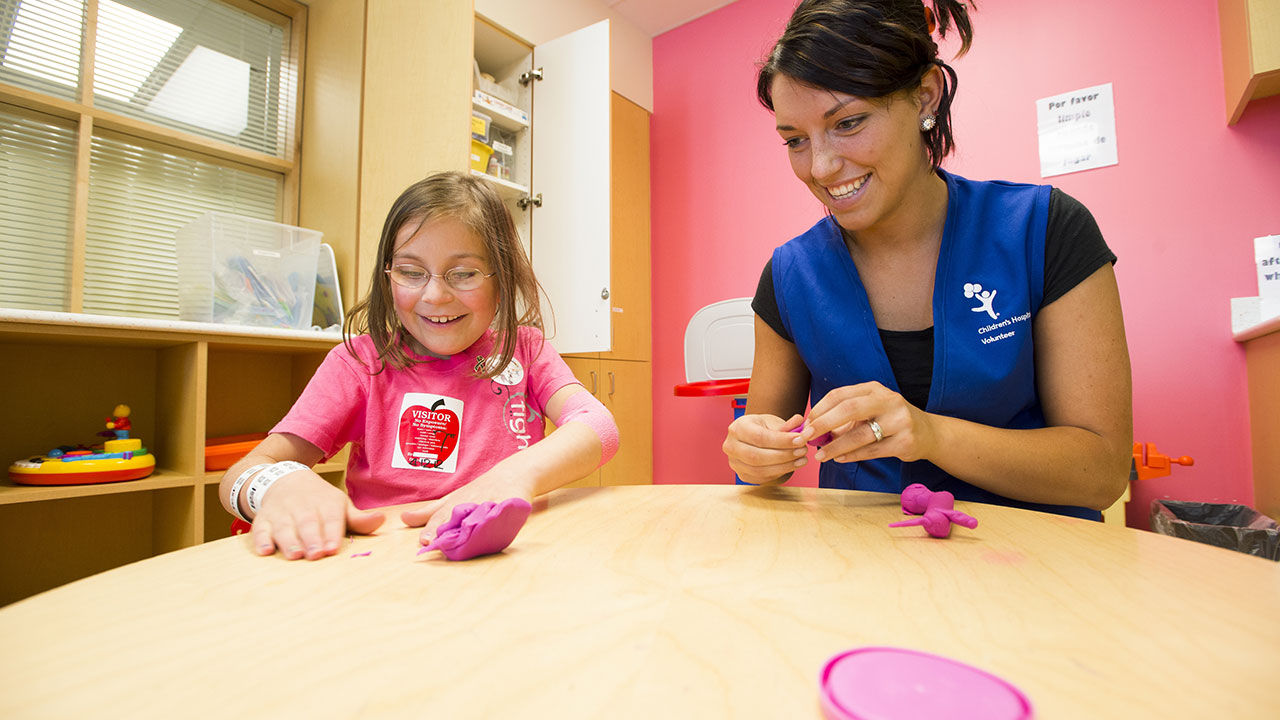 Child and volunteer in the Creative Play Center at Children’s Colorado