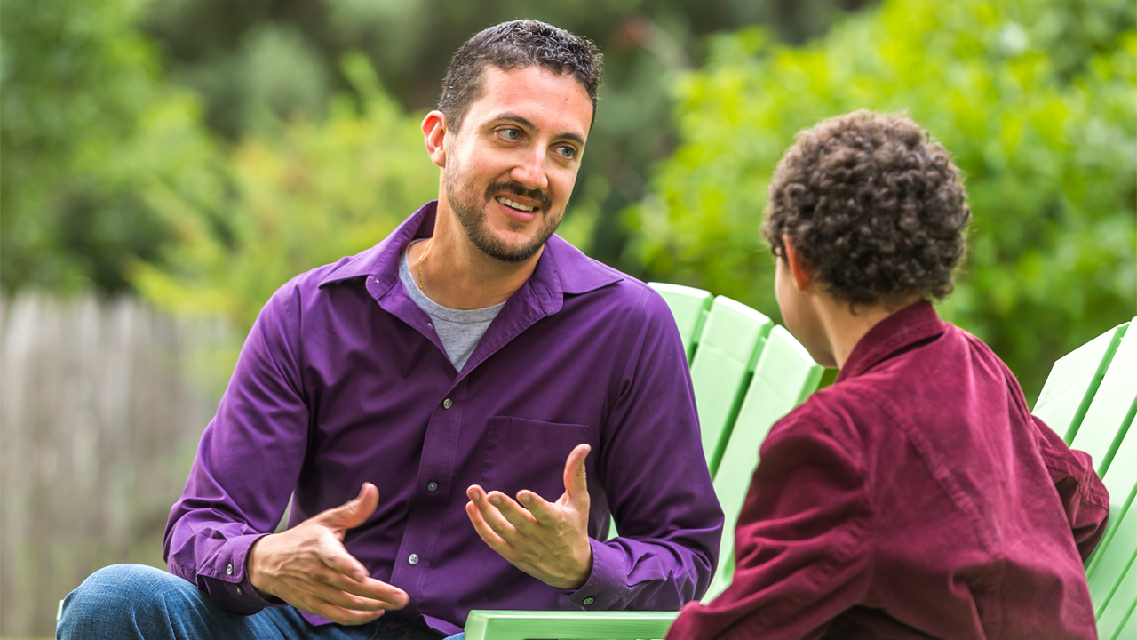 Parent talking to teen outside