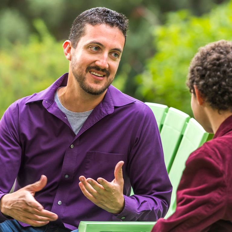 Parent talking to teen outside