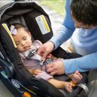 Father securing child in car