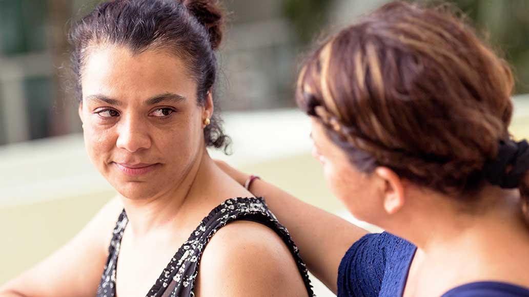 A woman comforts her friend.