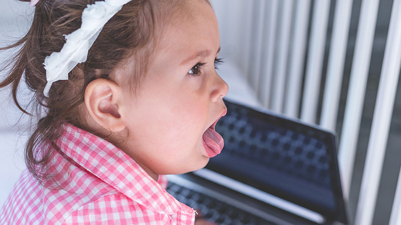 Young girl coughing.