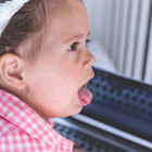 Young girl coughing.