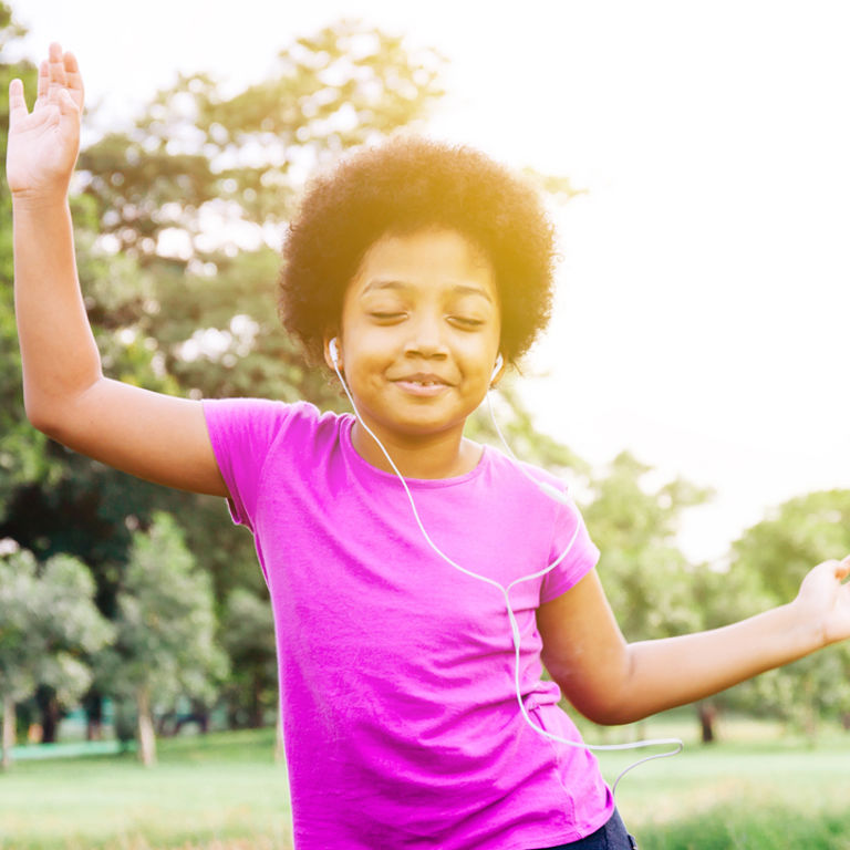 A child dances in the sunshine