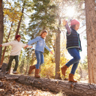 A group of children playing outdoors in the woods