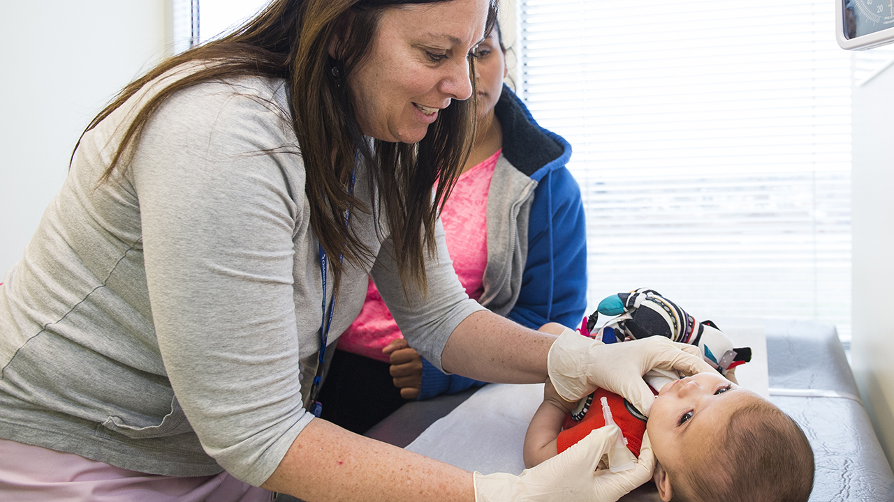 Physician doing check up on young child