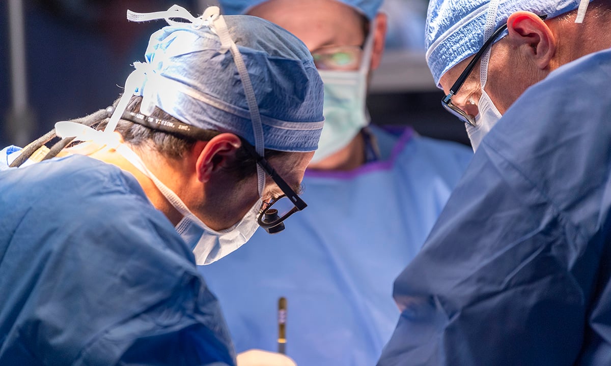 Three doctors performing cardiac surgery at Children’s Colorado.