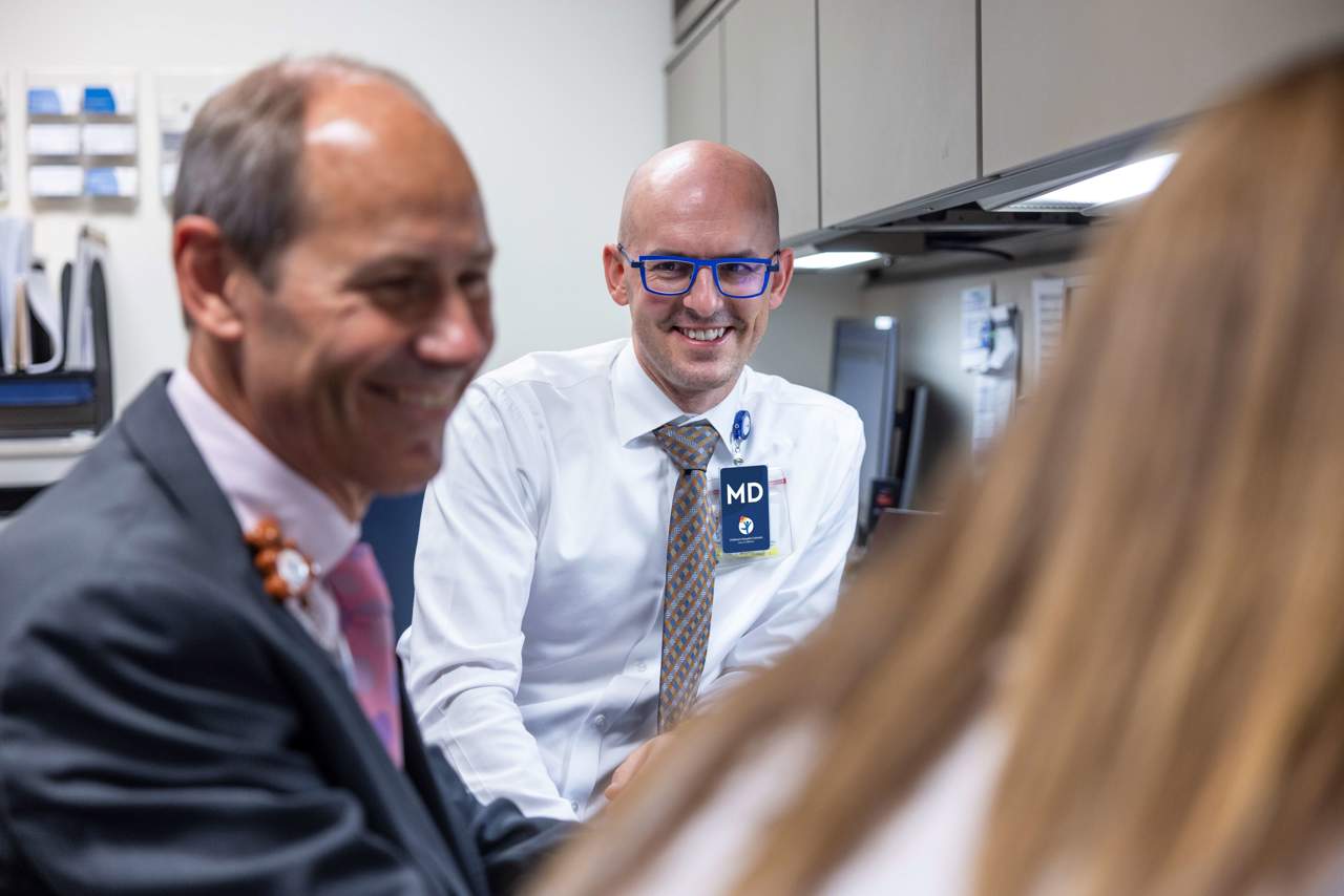 Dr. Duncan Wilcox and Dr. Kyle Rove, of Children's Hospital Colorado, speak with a pediatric urology patient.