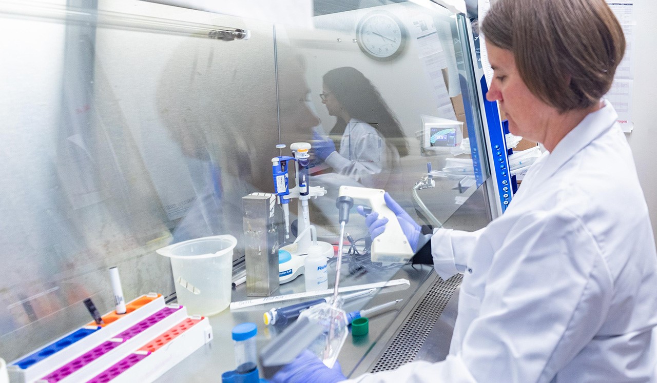 Dr. Mulcahy-Levy wears a white coat and conducts research in a lab at Children’s Hospital Colorado.