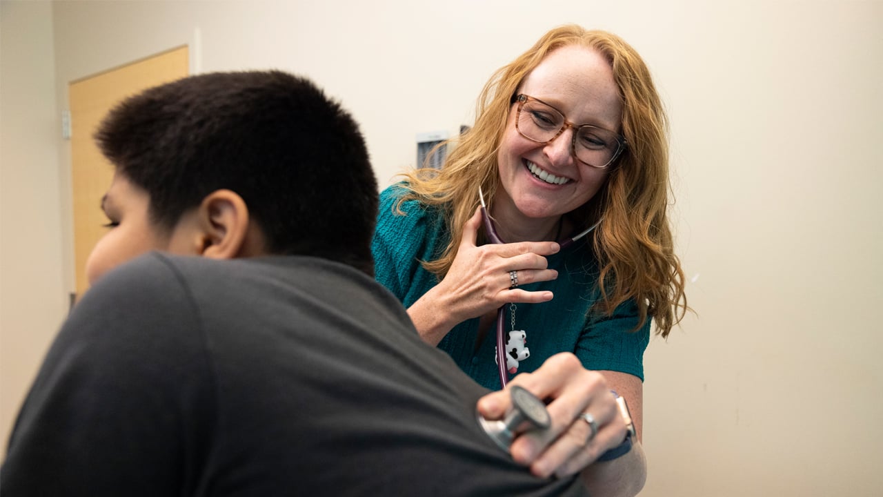 A pulmonologist examines a patient at Children’s Colorado.