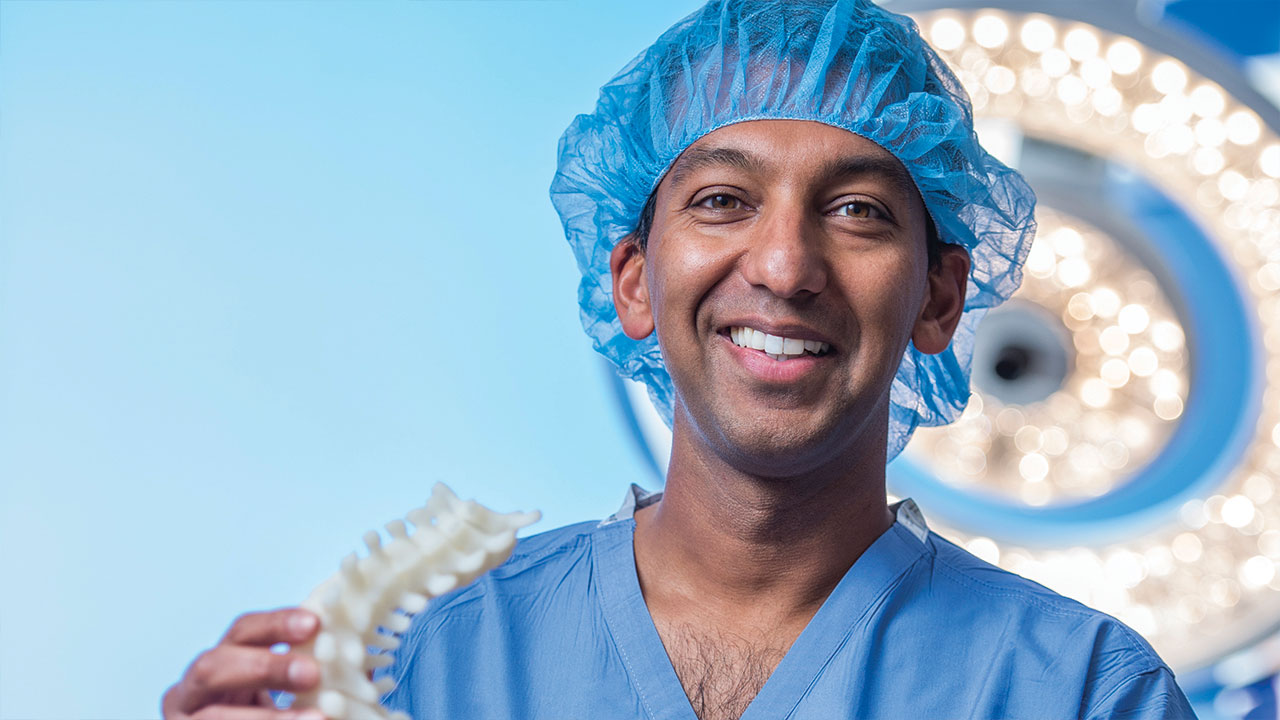 Dr. Sumeet Garg holds a 3d-printed spine.