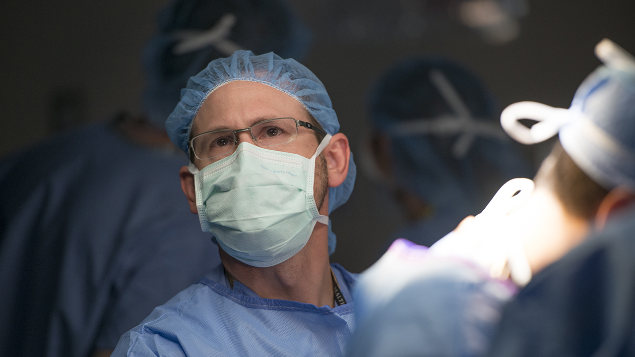 A doctor at the Colorado Fetal Care Center looks up during surgery.