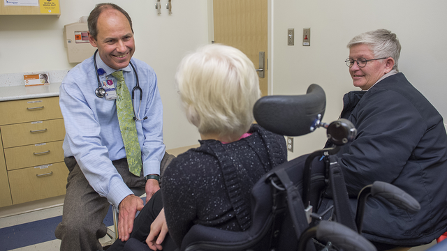 This image show Dr. Duncan Wilcox in exam room with a patient and her parent.