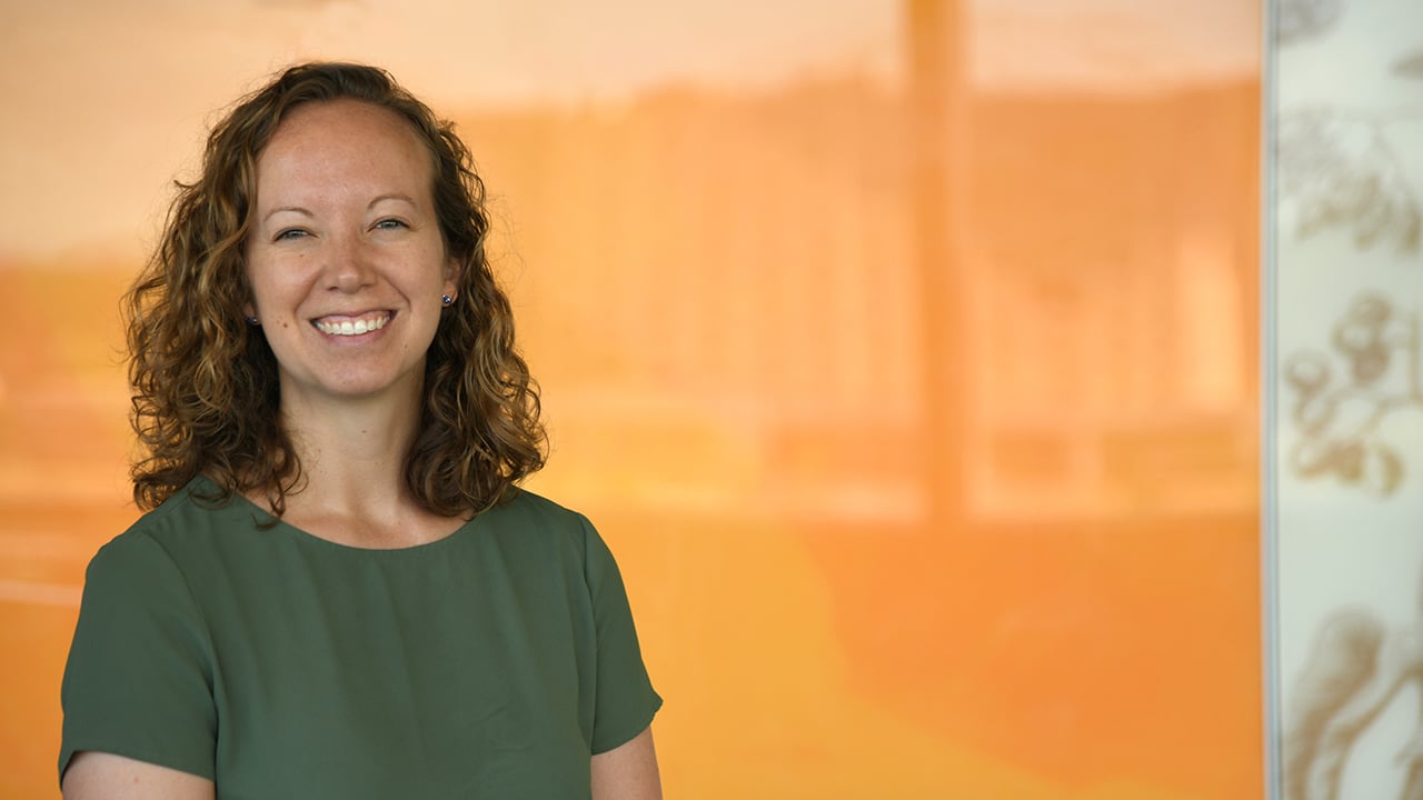 Dr. Caroline Hall on a yellow background