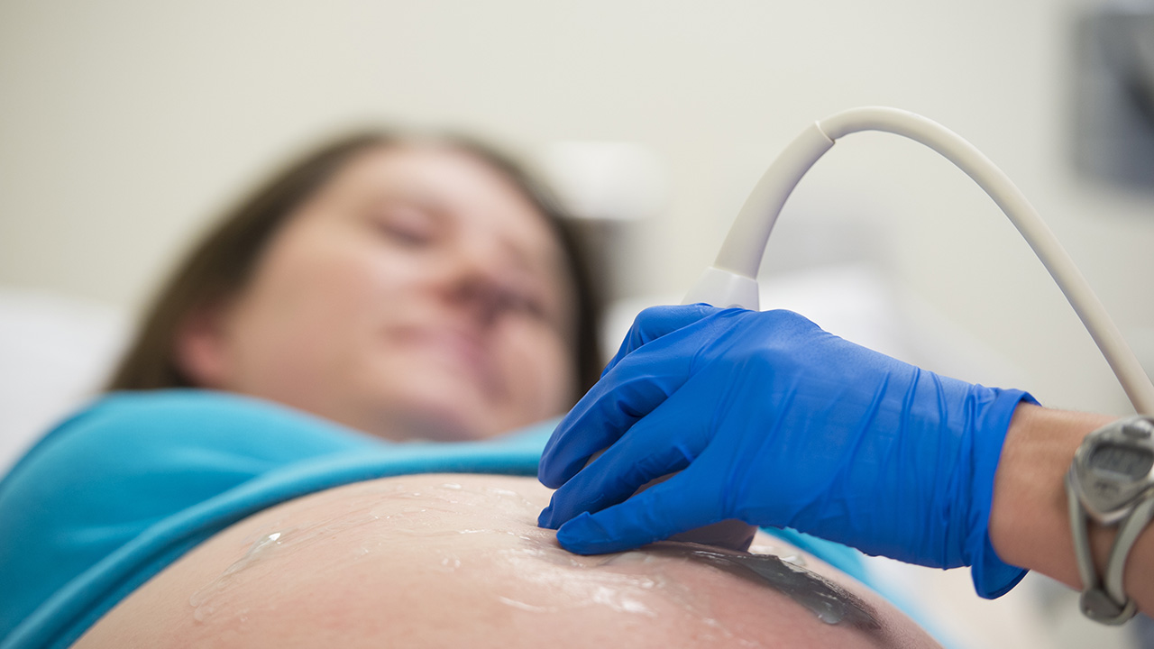 Woman receives ultrasound for pregnancy