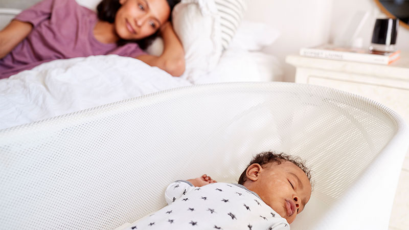 Mother watching her baby sleep.