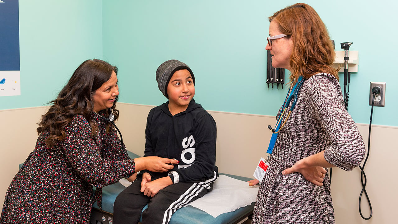 Physician talking with mother and son