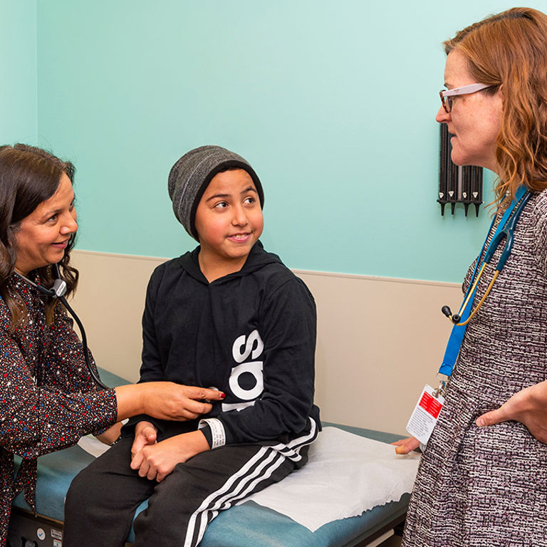 Physician talking with mother and son