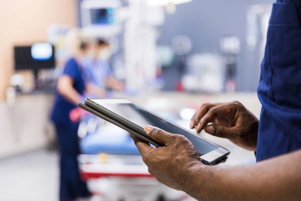 A closeup of a provider's hands while using an iPad