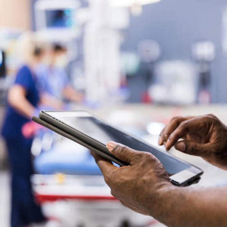 A closeup of a provider's hands while using an iPad