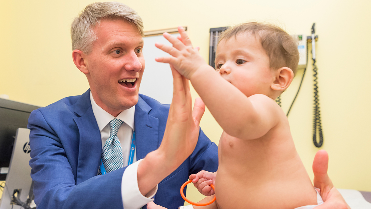 Dr. Nicholas Cost working with young girl