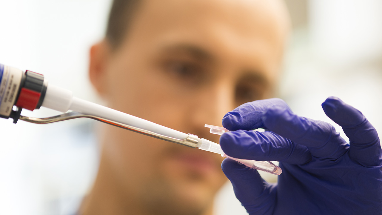 Researcher using syringe for sample