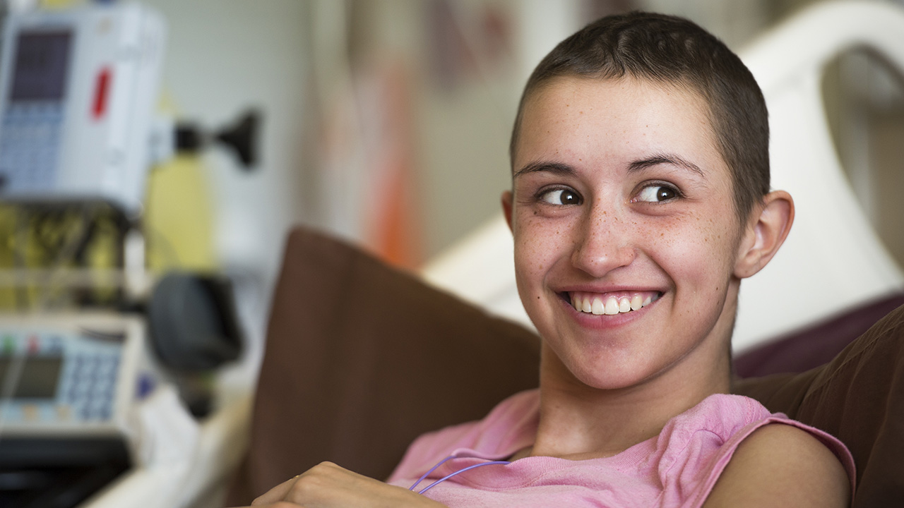 Close-up of adolescent cancer patient smiling