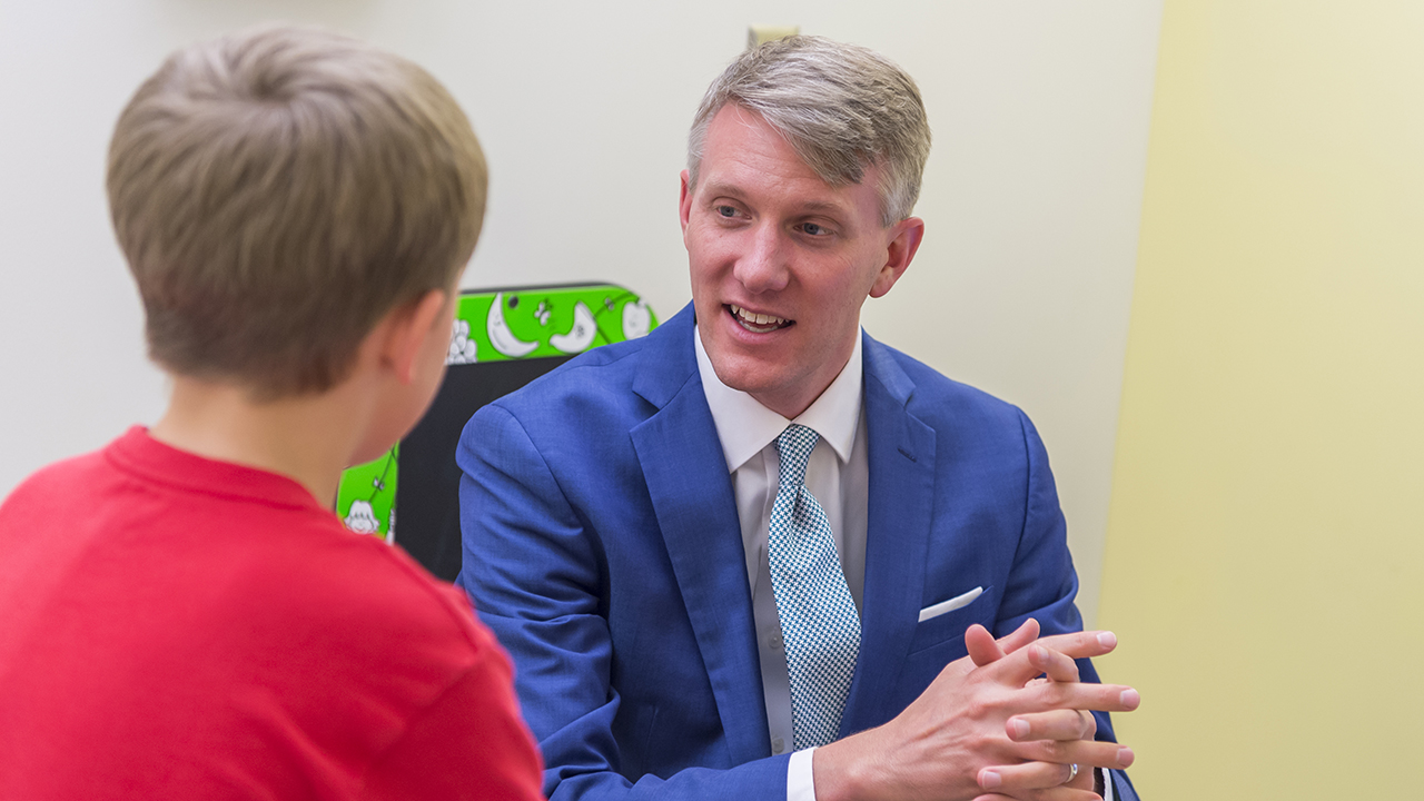 Dr. Cost speaking with a patient.