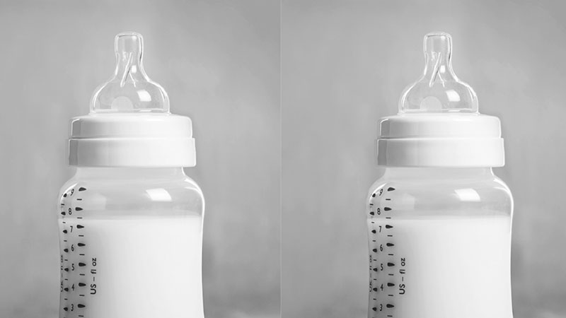 Two bottles of milk in baby bottles.