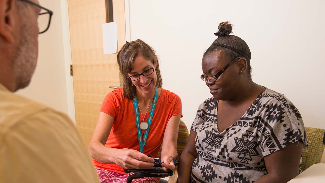 Clinician and research participant looking at a measurement.