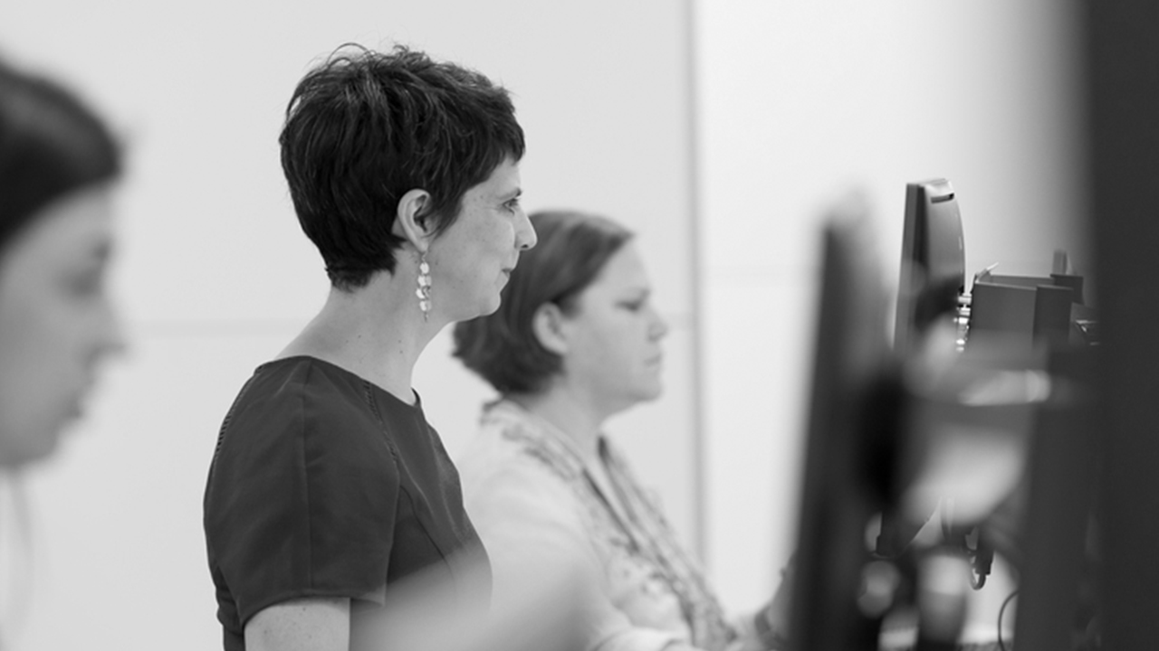 Black and white image of women at computers